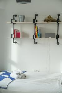 a room with a bed with shelves on the wall at Waterview apartments with ultra fast wifi close to Excel and O2, corporates and contractors welcome in London