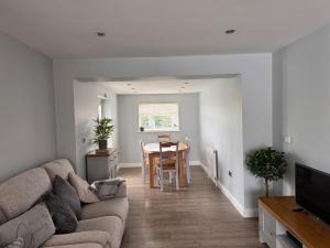 a living room with a couch and a table at Pet-Friendly - 2 Bedrooms Bungalow hot tub parking in Heacham