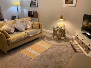 a living room with a couch and a television at Idyllic Two bed country cottage in Kirkby Thore