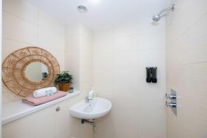 a white bathroom with a sink and a mirror at BRAND NEW Luxury Home by City SuperHost in Liverpool