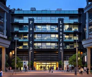 a large building with people walking in front of it at Casa Vacanze Asia Da Vinci's House in Fiumicino