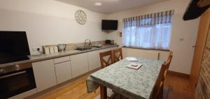 a kitchen with a table and a kitchen with a table and a tableablish at Mulberry Cottage near Goodwood in Chichester