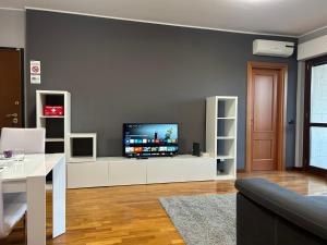 a living room with a flat screen tv on a wall at Casa Vacanze Asia Da Vinci's House in Fiumicino