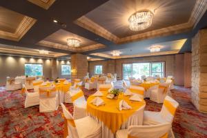 a banquet hall with tables and chairs in a room at Jardin Hotels Teen Imli in Indore