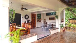 a porch of a house with a table and chairs at The Balete Resthouse in Camotes Islands