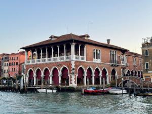 a building on the water with boats in front of it at Nama Boutique Residence in Venice