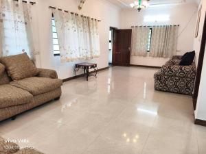a living room with a couch and a table at Hill Street Service Apartments in Hyderabad