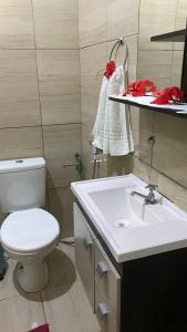 a bathroom with a white toilet and a sink at Casa da Cida in Fernando de Noronha +23 photos