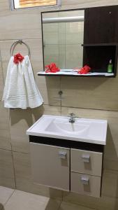 a bathroom with a sink and a mirror at Casa da Cida in Fernando de Noronha