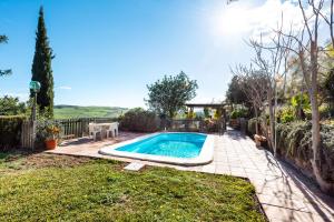 a swimming pool in the backyard of a home at Casa Rural Villa Campito Antequera in Antequera