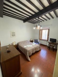 a bedroom with a bed and a table in it at Casa dell Erbe in San Gimignano