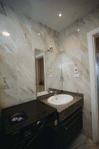 a bathroom with a sink and a mirror at Selina Bay Resort in El Gouna