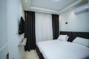 a bedroom with two beds and a television in it at Selina Bay Resort in El Gouna +20 photos