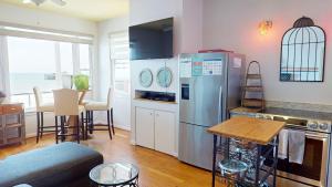 a kitchen with a stainless steel refrigerator and a table at 2 Delightful in Folly Beach