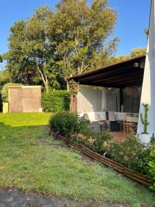 a backyard with a patio with a table and chairs at AffittaSardegna- Bilo Candido in Stintino