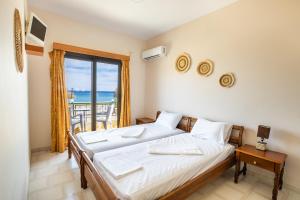 Postel nebo postele na pokoji v ubytování Sun Beach Apartments