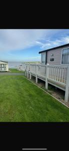 a house with a white fence next to the ocean at Waterfront Kent coast in Rochester