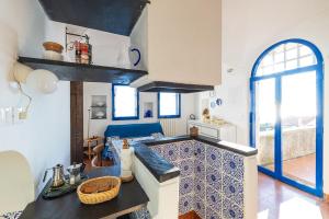 a kitchen with a blue and white counter in a room at Casa Maiolica in Finale Ligure