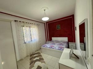 a small bedroom with a bed and a window at Olive Garden House 2 Bedroom Retreat in Durrës