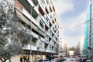 a city street with cars parked in front of a building at Vatican Cipro Guest House in Rome