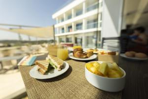 a table with plates of food on a table at Hotel Belvedere in Torre dell'Orso