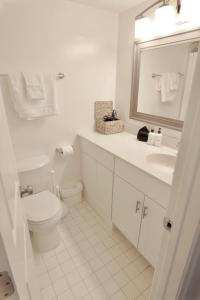 een witte badkamer met een toilet en een wastafel bij Capitol Hill & Penn - Steps from Eastern Market in Washington