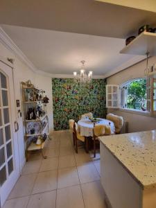 a kitchen with a table and a dining room at Casa Vinhedos in Caxias do Sul +49 photos