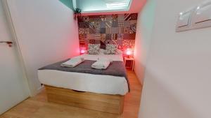 a small bedroom with a bed with two towels on it at Myflats Old Corner in Alicante +72 photos