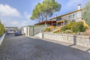 a house with a car parked on the side of a street at - venturural - in Venturada