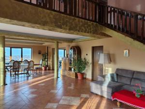 a living room with a couch and a table at VIS PENSION in Viile Satu Mare