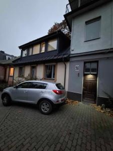 a silver car parked in front of a house at Maple Park Apartment in Kaunas