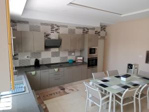 a kitchen with a table and chairs in a room at Villa lucky in Hammamet