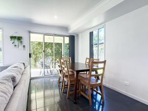 a dining room with a table and chairs at Coomera Comfort - Family Home Great for Play or Work, mins to Coomera Westfield n Theme Parks in Gold Coast
