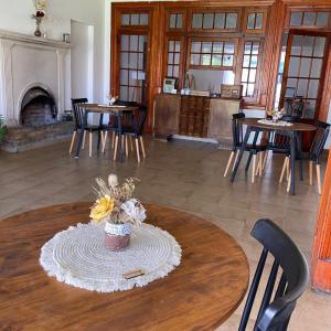 a room with a table with chairs and a fireplace at Sayani Posada in Chilecito