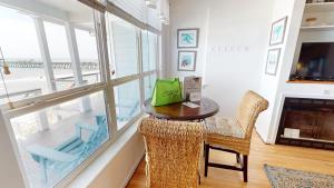 a dining room with a table and chairs and a large window at Beautiful Sunrise in Folly Beach
