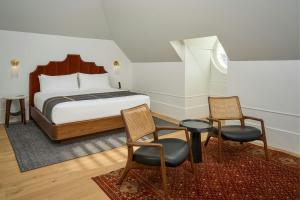 a bedroom with a bed and two chairs and a table at Asher Adams, Autograph Collection in Salt Lake City +121 photos