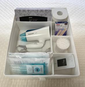a drawer filled with various items in a box at #3 新宿まで2分! 清潔で安全な部屋! WiFi無料! in Tokyo