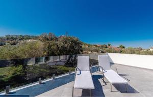 a group of white chairs sitting on a balcony at 3 Bedroom Stunning Home In Tkon in Tkon +32 photos
