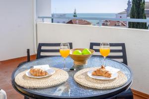 a table with two glasses of orange juice and croissants at Bay View by OCvillas in Albufeira