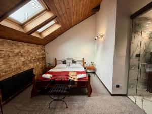 a bedroom with a bed and a glass shower at Hotel Plzeňský Dvůr in Frýdek-Místek