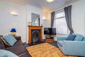 a living room with a couch and a television at Beeston town house - Sleeps 4 in Beeston