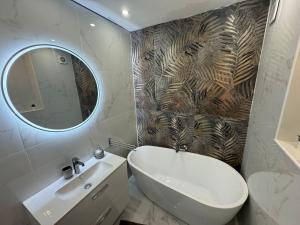 a bathroom with a white sink and a mirror at Apartament with sea view in Nice
