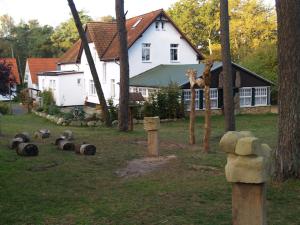 a house with a bunch of animals in the yard at Gaststätte und Pension Zum Klausner in Kloster