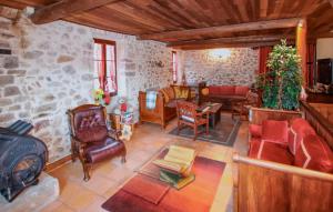 a living room filled with furniture and a stone wall at Amazing Home In Chassiers With Wifi in Chassiers