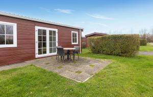 a patio with a table and chairs in a yard at 3 Bedroom Lovely Home In Wagenborgen in Wagenborgen +21 photos