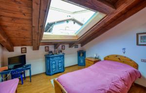 a bedroom with a bed and a window at Lovely Apartment In San Vito Di Cadore in San Vito di Cadore