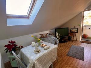 a dining room with a table with a white table cloth at Islay View- Double Bed Apartment (NITB APPROVED) in Castlerock