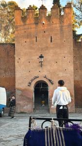 a man standing in front of a castle at Casa Andalucia in Chefchaouene