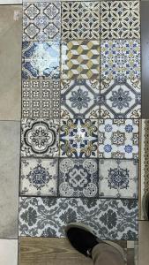 a tile floor with a persons shoe on the floor at Casa Andalucia in Chefchaouene