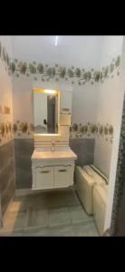 a bathroom with a sink and a mirror at بيت دار السوداء in Dār Sawdāʼ